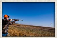 Taking aim to knock down a rooster in flight