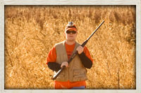 Hunter walking through the field ready to take his next shot.